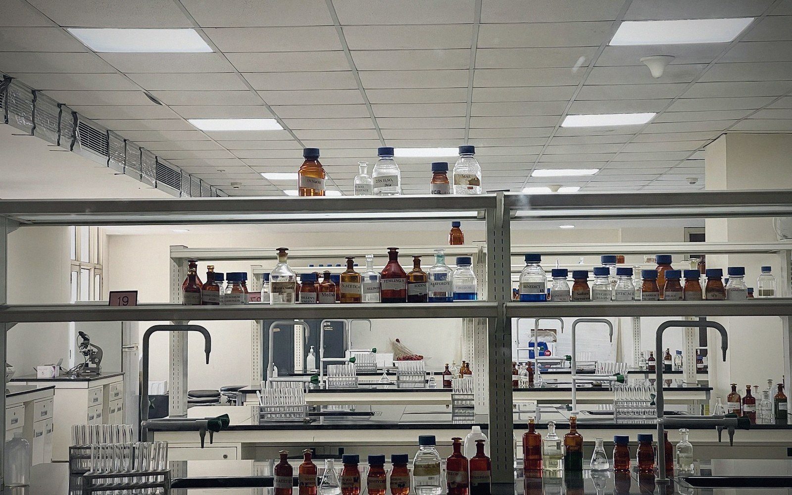 An analytical laboratory bench, stainless and glass, hard light